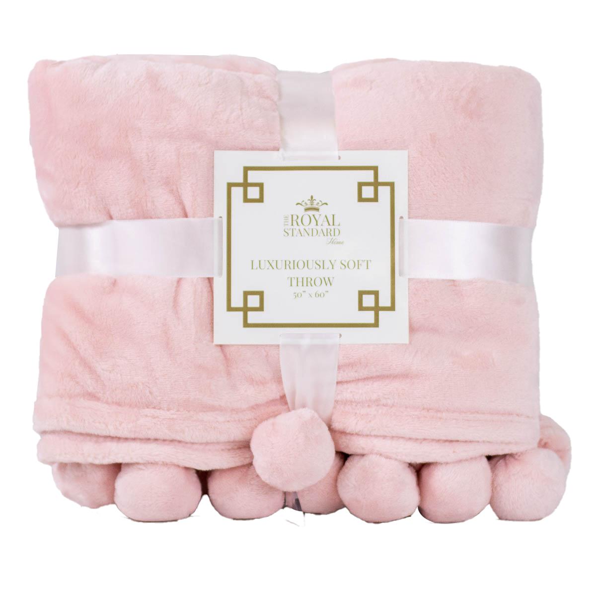 The Cozy Pom Pom Throw in light pink, soft polyester, size 50" x 60", wrapped with a white ribbon.