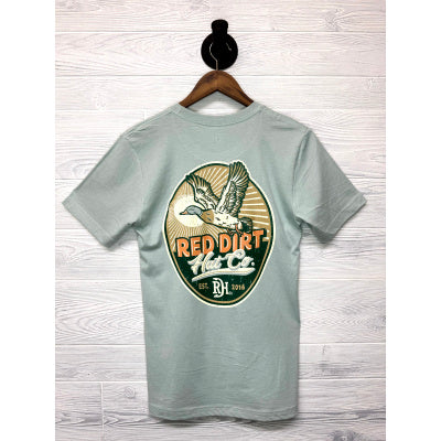 The Big Duck Energy T-Shirt features a flying duck over a sunset and "Red Dirt Hat Co EST. 2016" on back. Sizes S-XXL available.