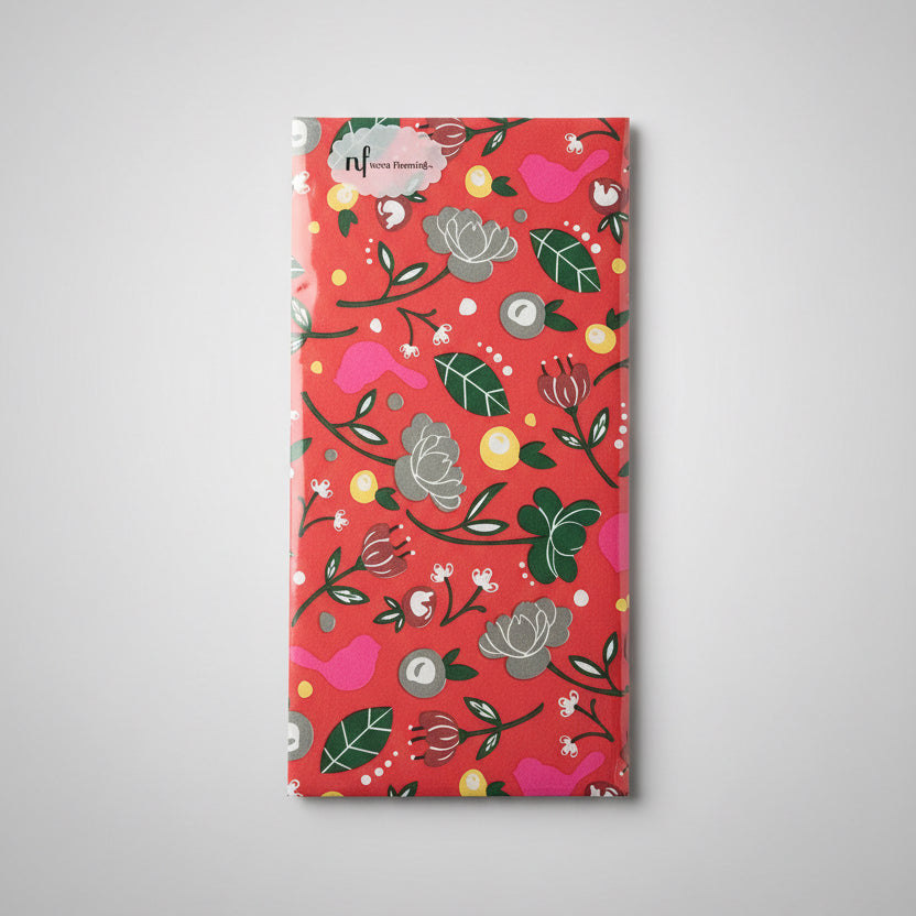 Rectangular pack of Cardinal Guest Towels wrapped in floral paper, red, green, white, and yellow. Available in standard sizes.