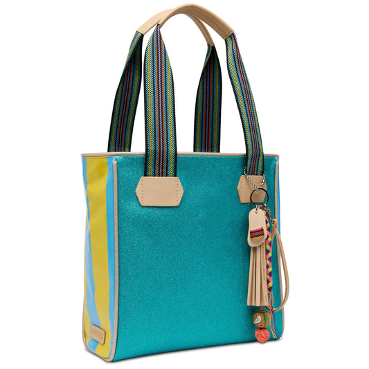 The Classic Tote, Lumi: turquoise sparkly texture, yellow/blue sides, striped handles, tassels. Sizes: Small, Medium, Large.