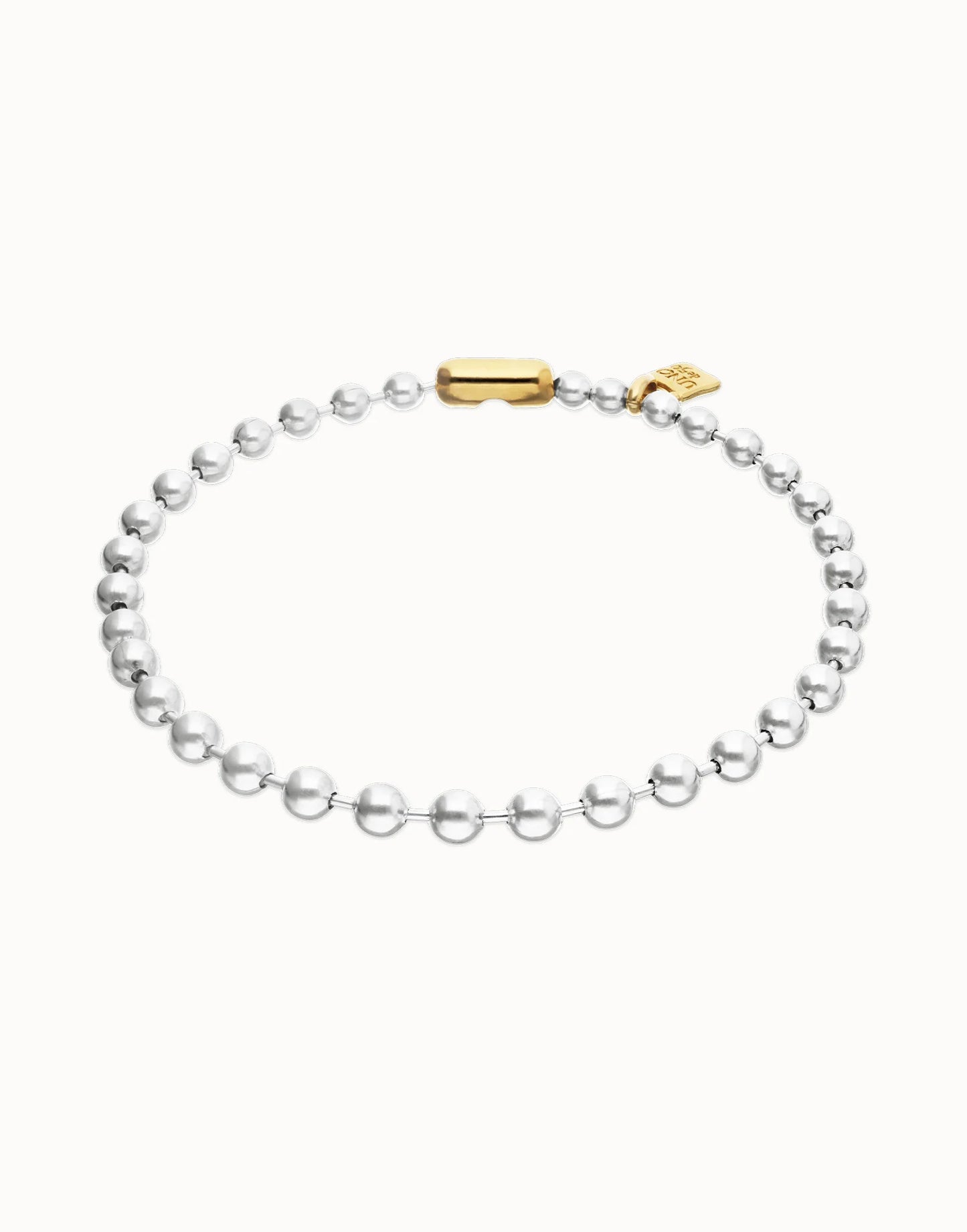 Delicate silver beaded necklace with a gold clasp and small gold tag from the Pálpito Collection, available in multiple sizes.