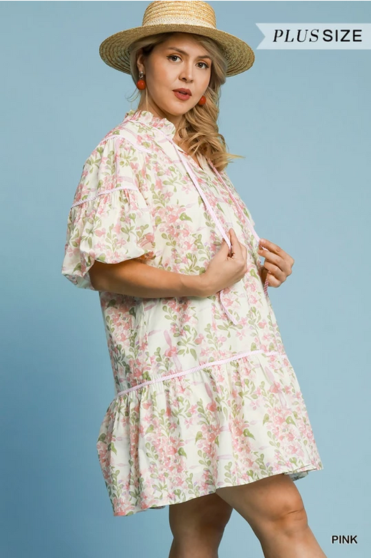 Floral Everlee Dress: pink mini dress with floral print, ruffled sleeves and hem. Available in sizes XS-XL.