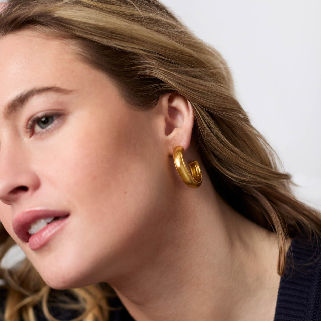 Cannes Hoop Gold Earrings, available in small and medium sizes, shown in detail with a subtle gold finish.