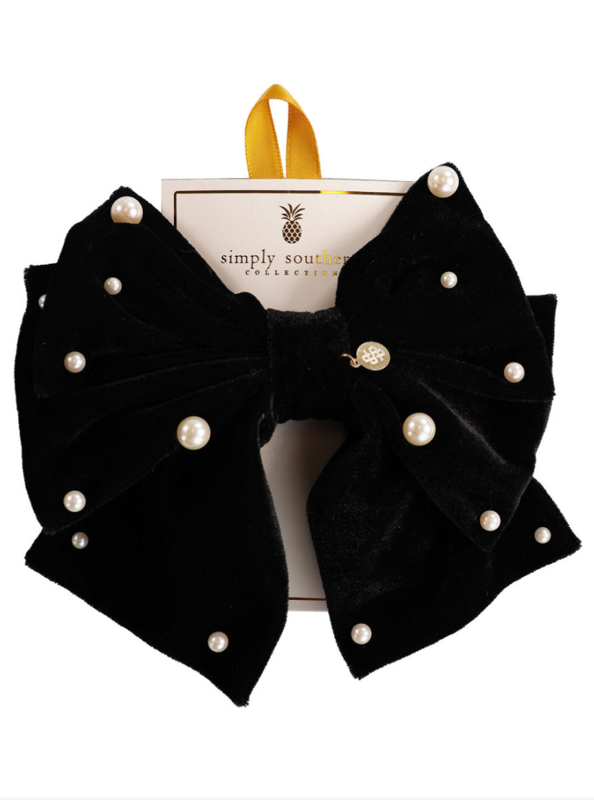 Large black velvet bow with pearl-like beads from Simply Southern. Sizes available: large. Yellow hanging ribbon attached.