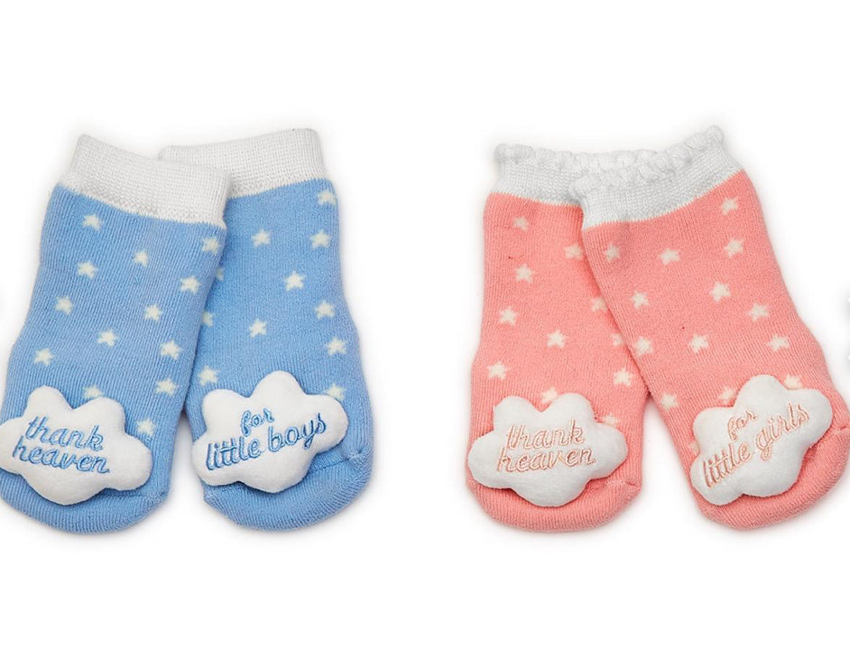 Thank Heaven Rattle Socks for babies. Blue pair with "thank heaven for little boys" on a cloud. Pink pair with "thank heaven for little girls" on a cloud. Sizes: Newborn-6 months, 6-12 months.