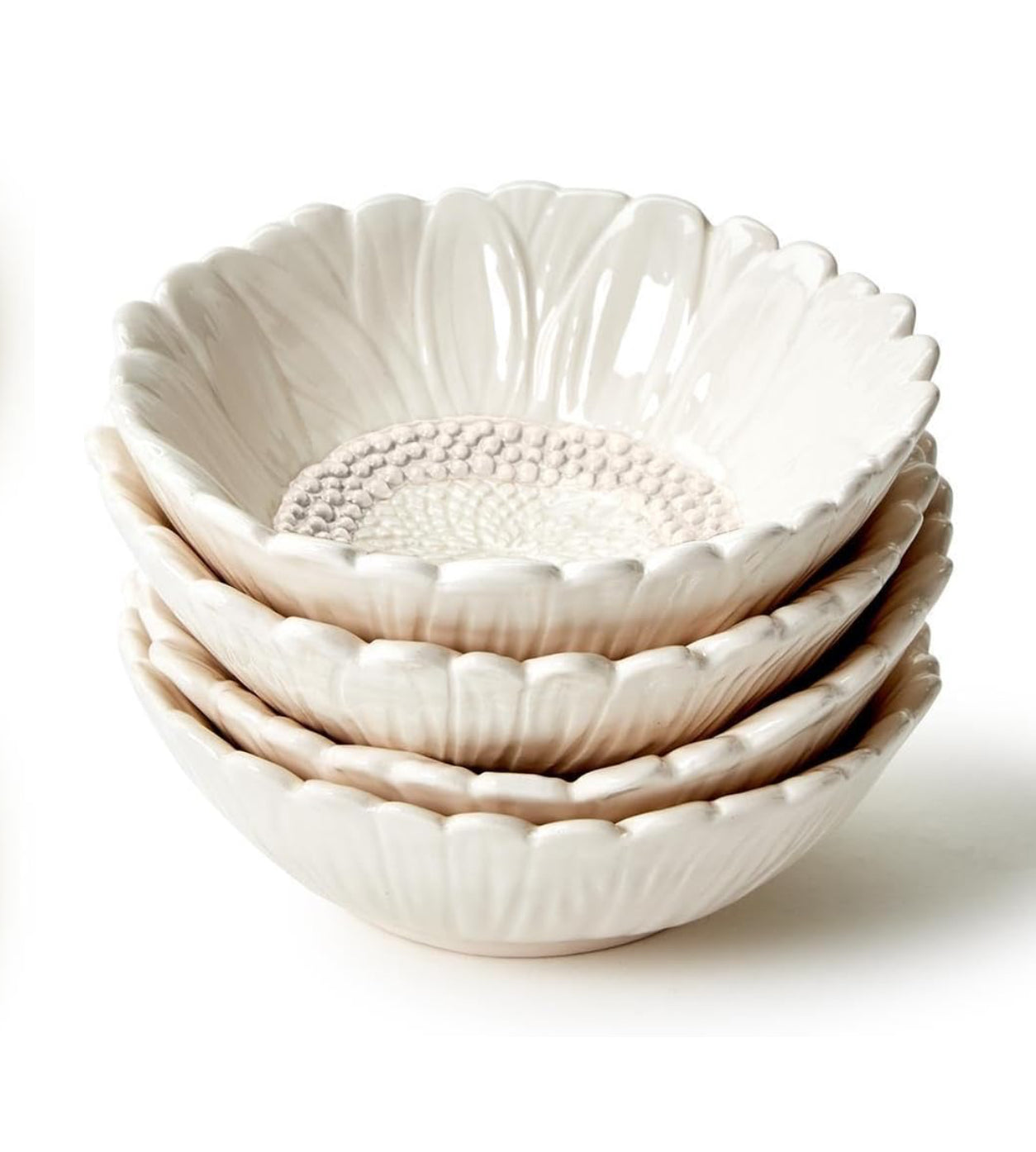 Four cream ceramic Sunflower Bowls with petal rims, textured centers, dishwasher safe. Available in small and large sizes.