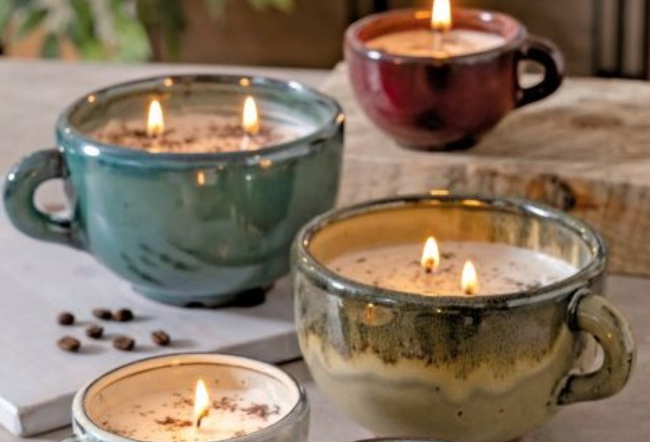 Four lit Large Coffee Cup Roasted Espresso candles in colorful cups, each surrounded by espresso beans. Available in large size.