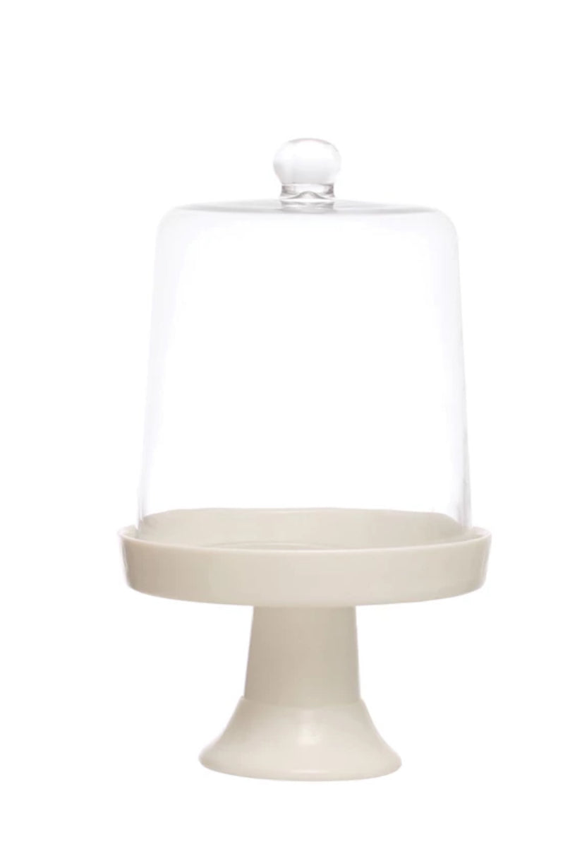 Set of 2 white ceramic pedestals with clear glass cloches; available in two sizes.