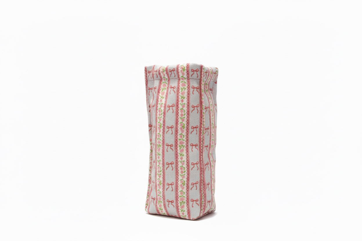 Rectangular, upright pouch with red bow and green dot stripes on white. Available sizes: small, medium, large.