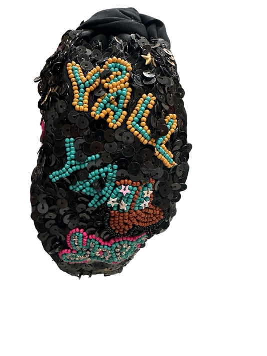 Black headband adorned with black sequins and colorful beads spelling "Y'ALL." Available in one size.