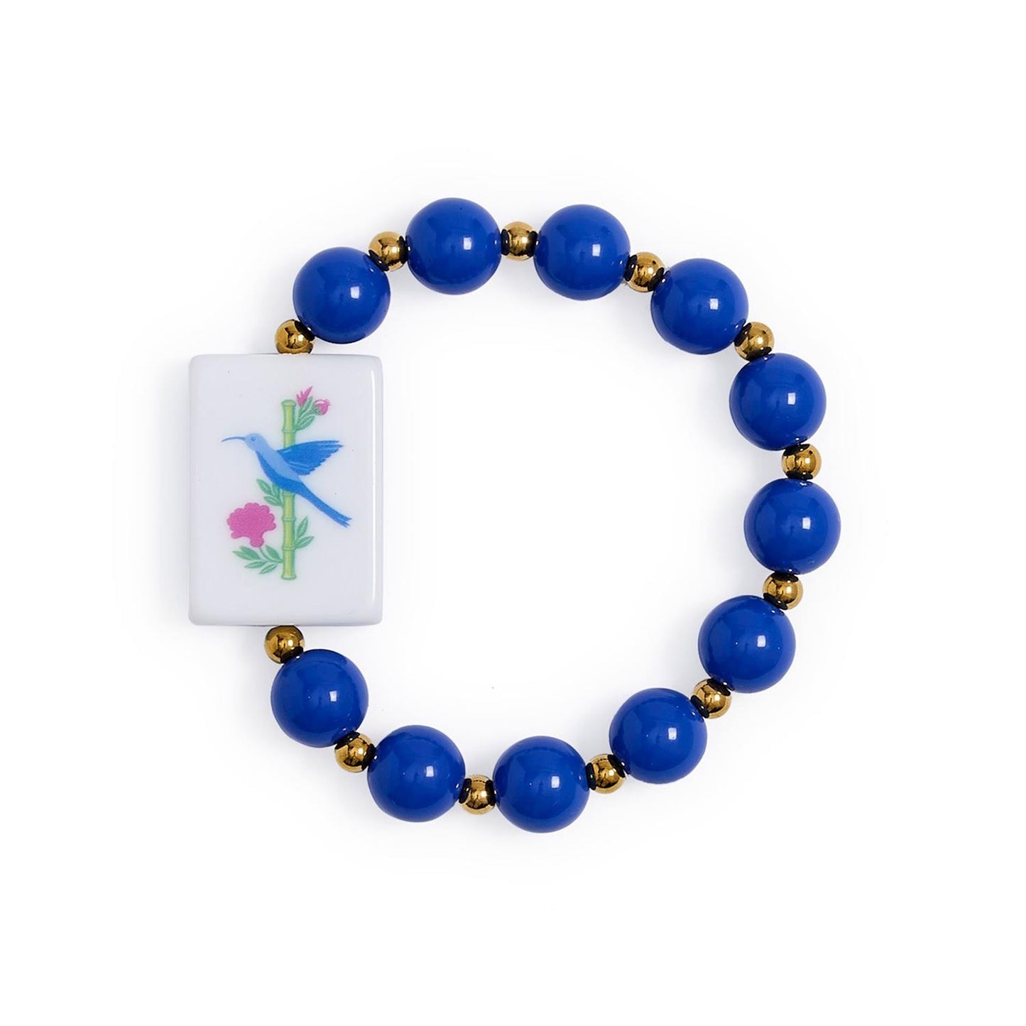Mahjong Beaded Stretch Bracelet features alternating large blue and small gold beads, a rectangular white charm with a blue bird on a pink-flowered branch, and colorful acrylic Mahjong-inspired accents. Available in multiple sizes.