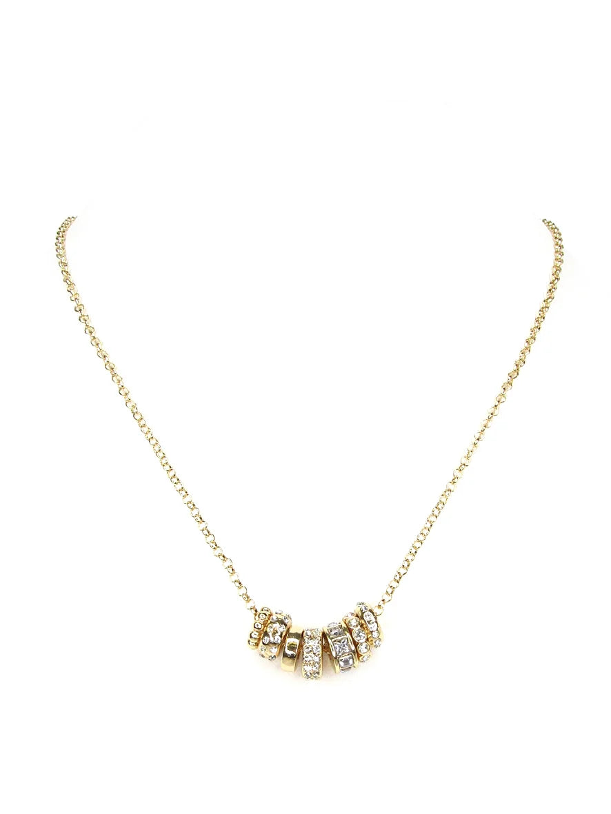 Far Gold Charm Necklace with five gold and rhinestone-studded ring charms at the center; available in 16, 18, and 20-inch lengths.