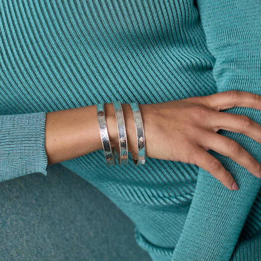 Wide hammered Savoy Bangle - Silver, shown in a set of three. Available sizes: S, M, L.