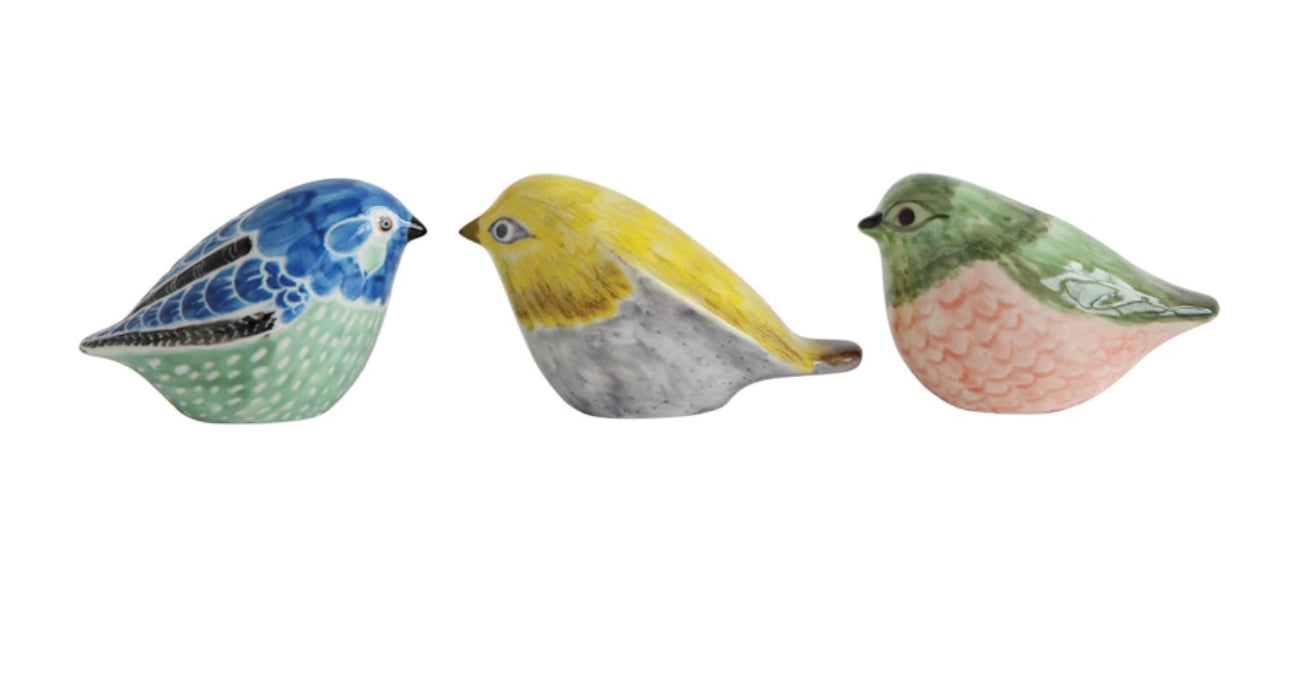 Hand-painted stoneware birds in blue, yellow, or green-pink with distinct patterns. Available in small, medium, and large sizes.