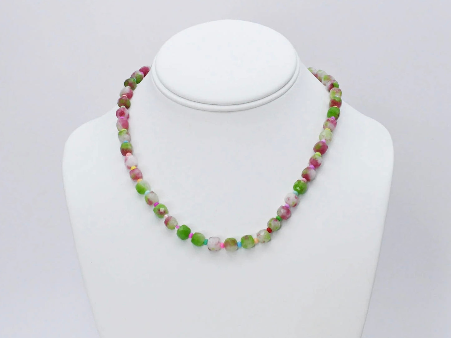 The Camo Girly Necklace by Treasure Jewels has round, faceted beads in green, pink, white, and beige. Sizes available.