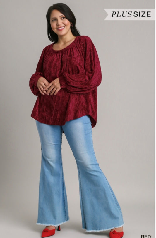 Velvet High Low Long Sleeve Top is available in plus sizes. It features a high low hem design. The product also includes blue flared jeans.