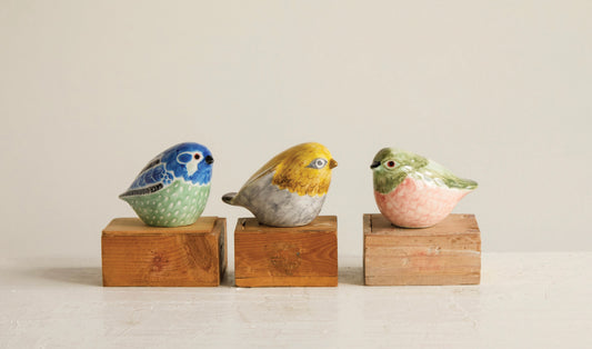 Set of three hand-painted stoneware bird figurines in blue, yellow, and green. Available sizes: small, medium, large.