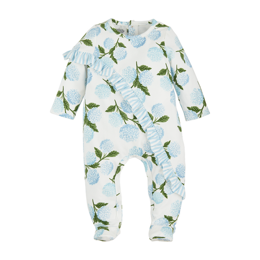 A baby's long-sleeve Hydrangea Ruffle Baby Sleeper with an allover pattern of blue raspberries and green leaves, featuring ruffle details on the shoulders, displayed on a white background.