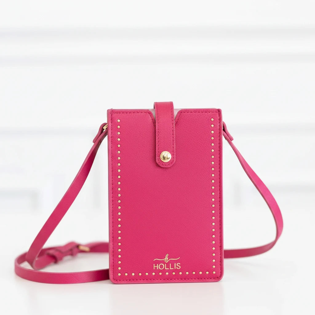 Beige crossbody purse with gold studs, snap closure, "HOLLIS" logo. Available in one size. Fits most cell phones.