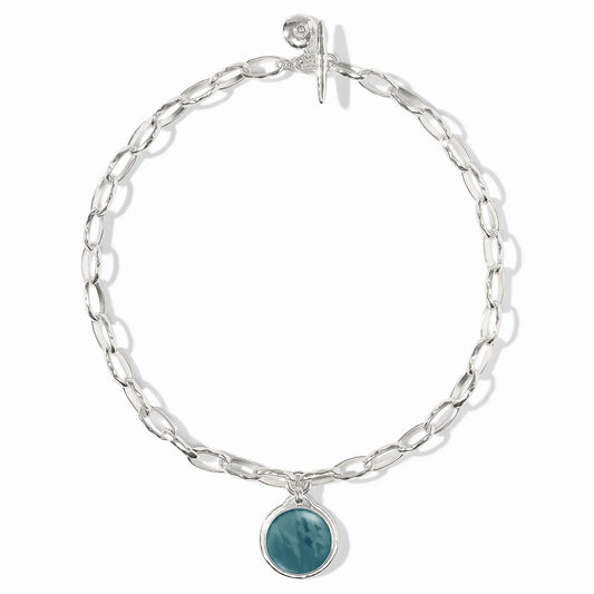 Elongated silver links, round iridescent Montana Blue stone charm, toggle clasp. Available in 16", 18", and 20" lengths.