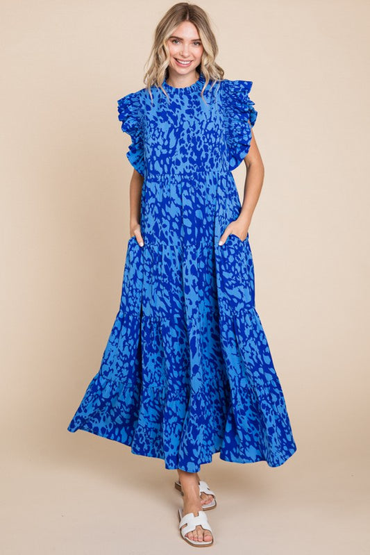 Vibrant blue, leopard-print maxi dress features ruffled sleeves and a flowing skirt. Available in various sizes.