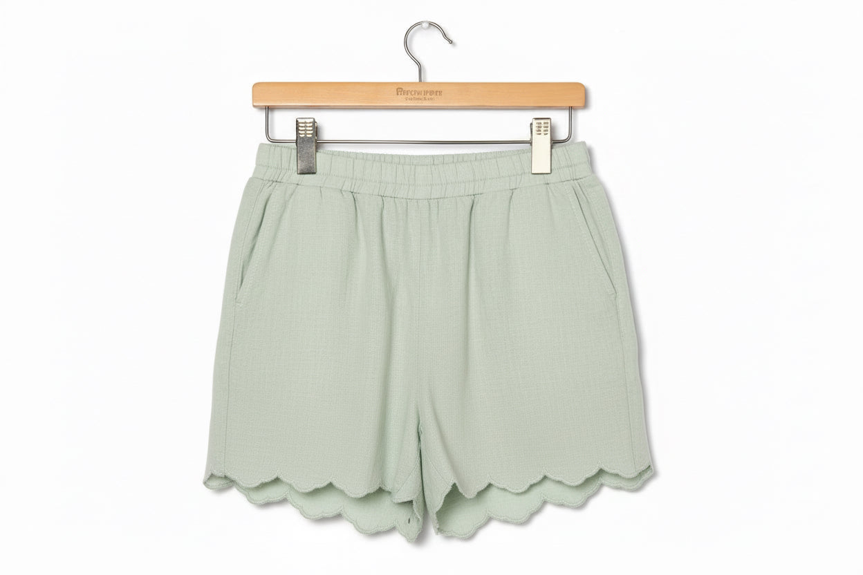 Light green Sage Scalloped Shorts with elastic waistband, side pockets, scalloped hems. Sizes: S-XL.