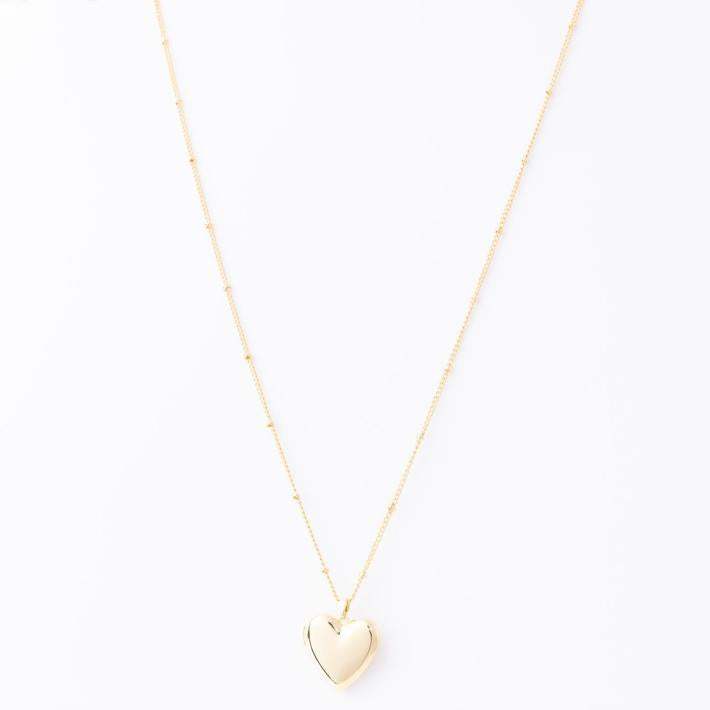 The Alexandra Locket Necklace: delicate gold chain, shiny heart-shaped locket pendant. Available in 16", 18", and 20" sizes.