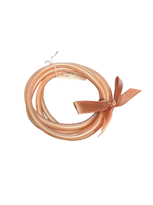 Set of three shiny, peach-colored bangles tied with a matching satin ribbon bow. Available in S, M, and L.