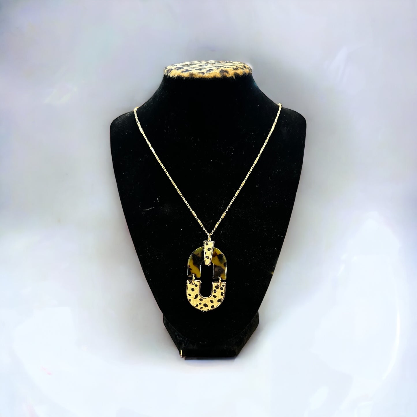 Gold chain necklace with large oval leopard-print pendant, gold patterns, lead and cadmium safe. Available in 16", 18", 20".