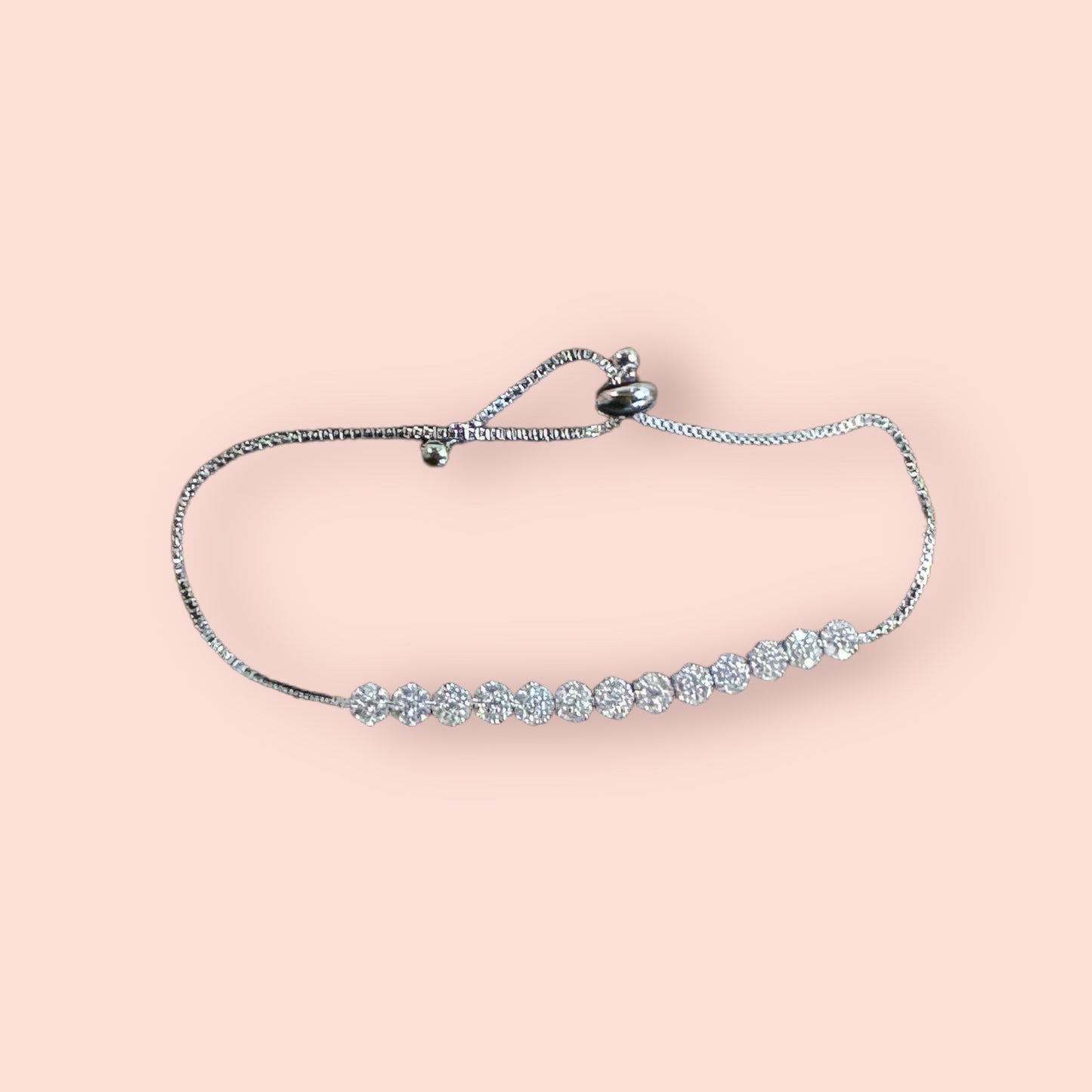 Diamond Circle Link Bracelet: delicate silver with round sparkling gemstones, adjustable sliding clasp; available in multiple sizes.