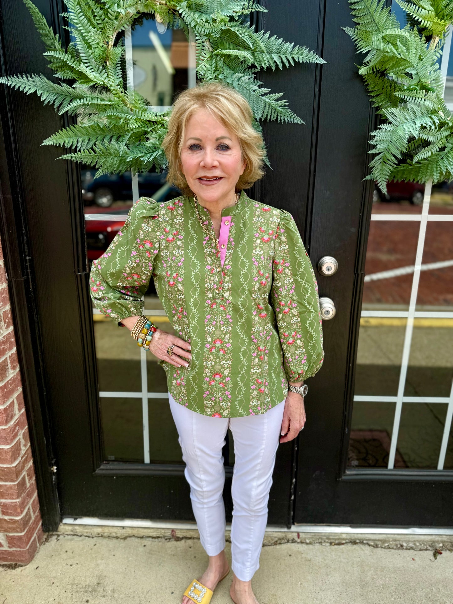 Green floral Lia Top with 3/4 puff sleeves. Available in sizes XS–XL.