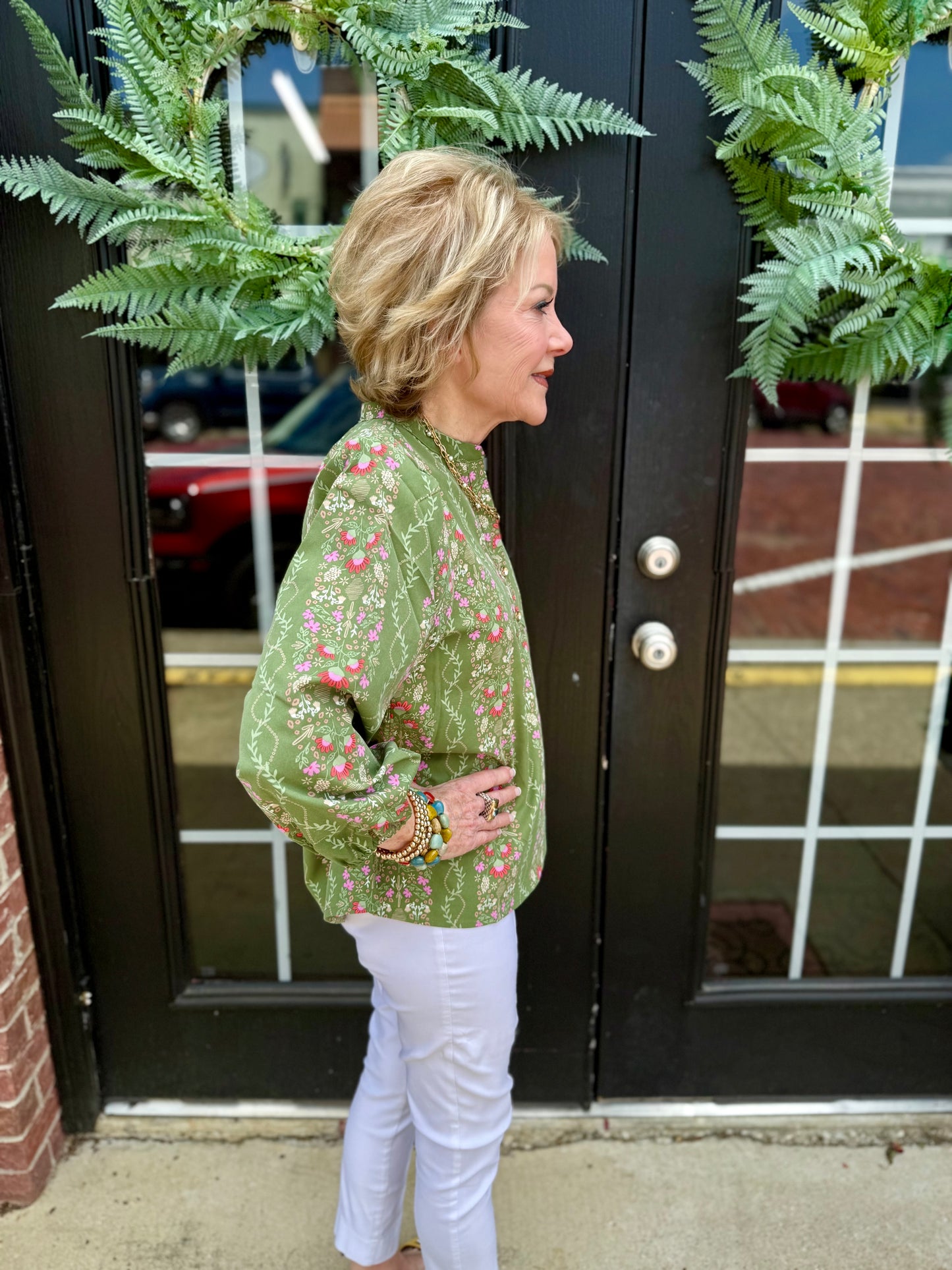 Lia Top: green floral blouse, quarter button collar, 3/4 puff sleeves. Available in XS–XL.