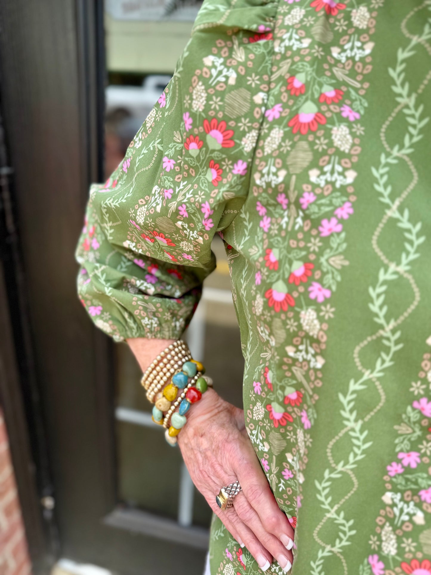 Lia Top in green floral with 3/4 puff sleeves, available in sizes XS-XL.