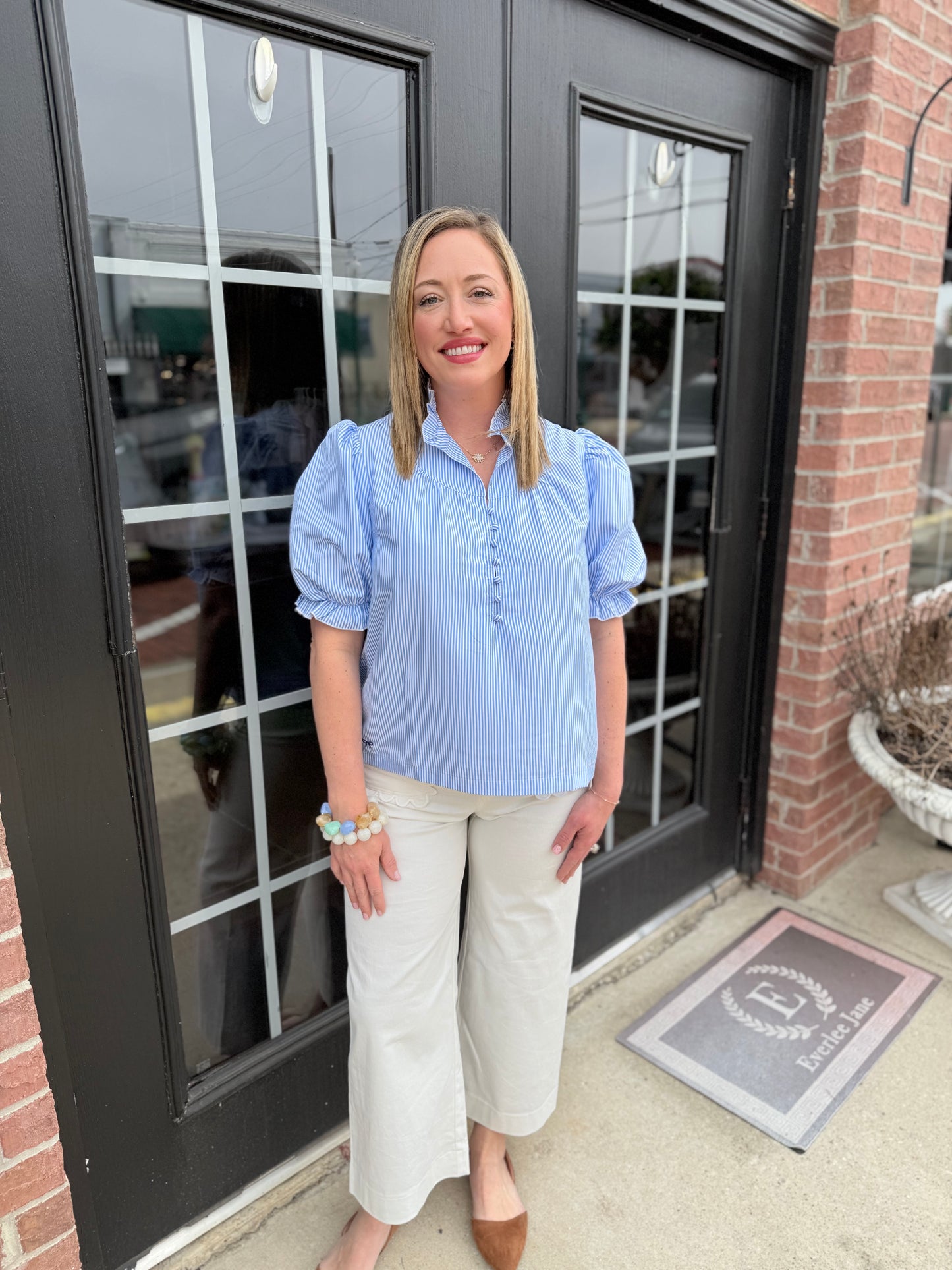 Seersucker Blue Striped Top, available in sizes XS-XL; lightweight fabric and relaxed fit for versatile styling.