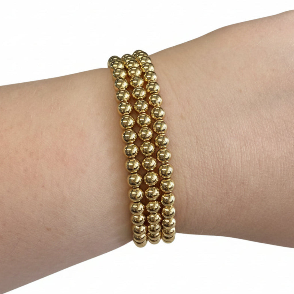 Beaded Gold Dipped Stretch Bracelets with shiny gold round beads. Available in S, M, L sizes.