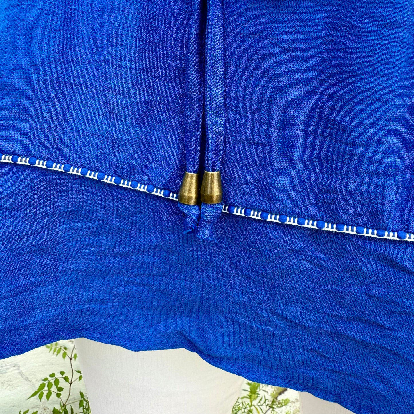Royal blue blouse with white embroidery, lace trim, and tassels. Available in XS–XL.