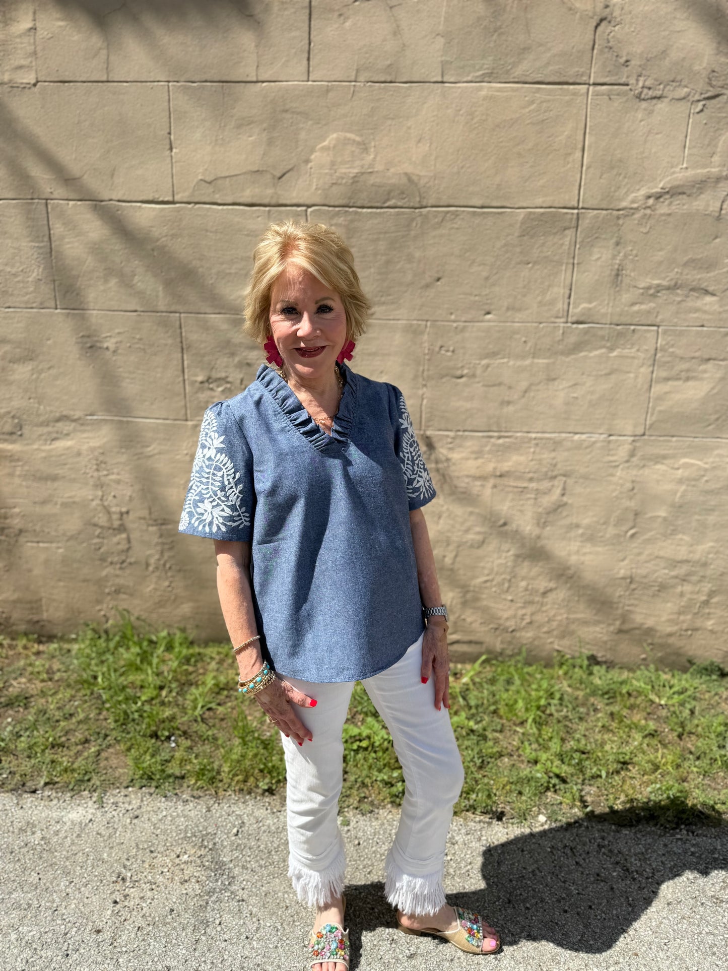Denim Floral Top with ruffle V-neck and patterned sleeves. Available in sizes S-XL.