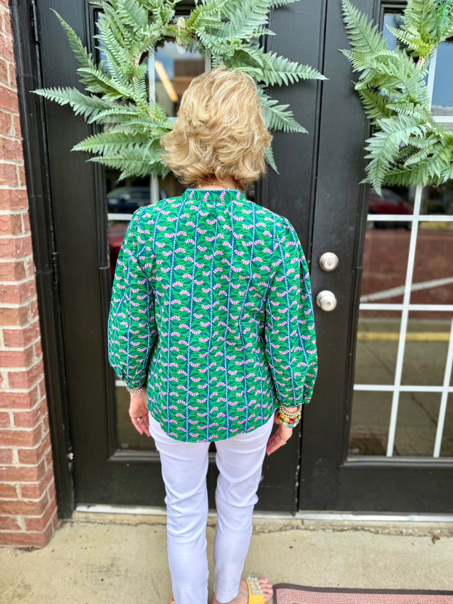 Lia Top: green patterned blouse with 3/4 puff sleeves, available in sizes XS-XL.
