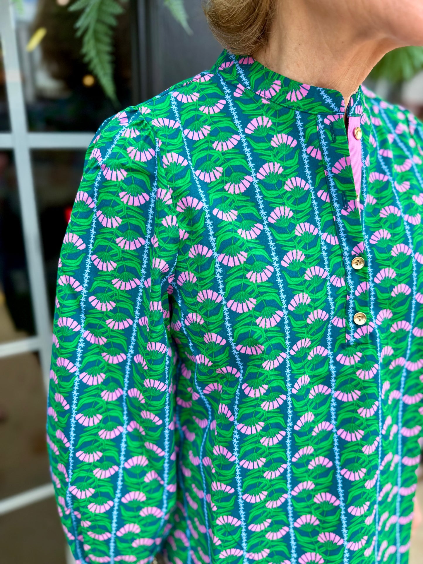 Lia Top: green, blue, pink, and white floral blouse with 3/4 puff sleeves, button detail, quarter-button collar. Sizes XS–XL.
