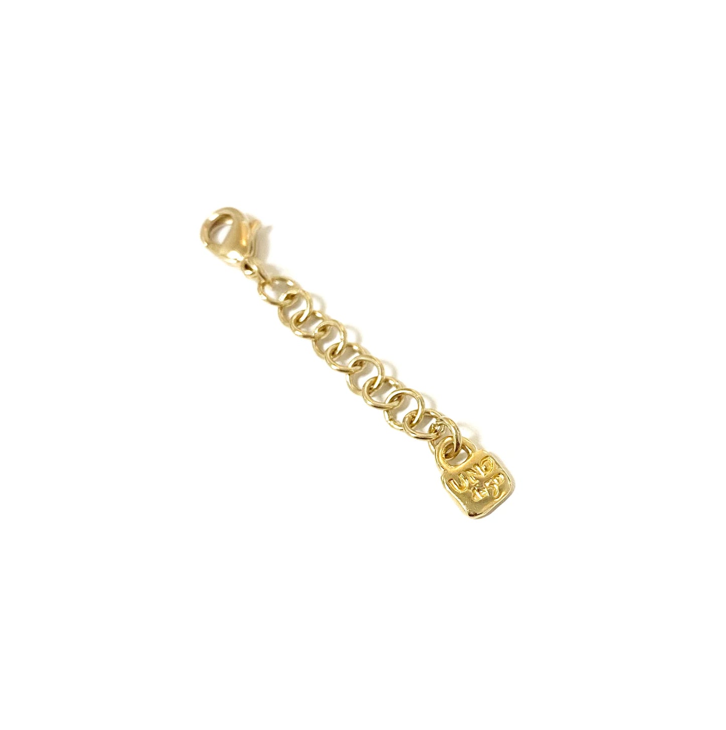 Short gold chain extender with round links and a small rectangular UNOde50-engraved tag; available sizes not specified.