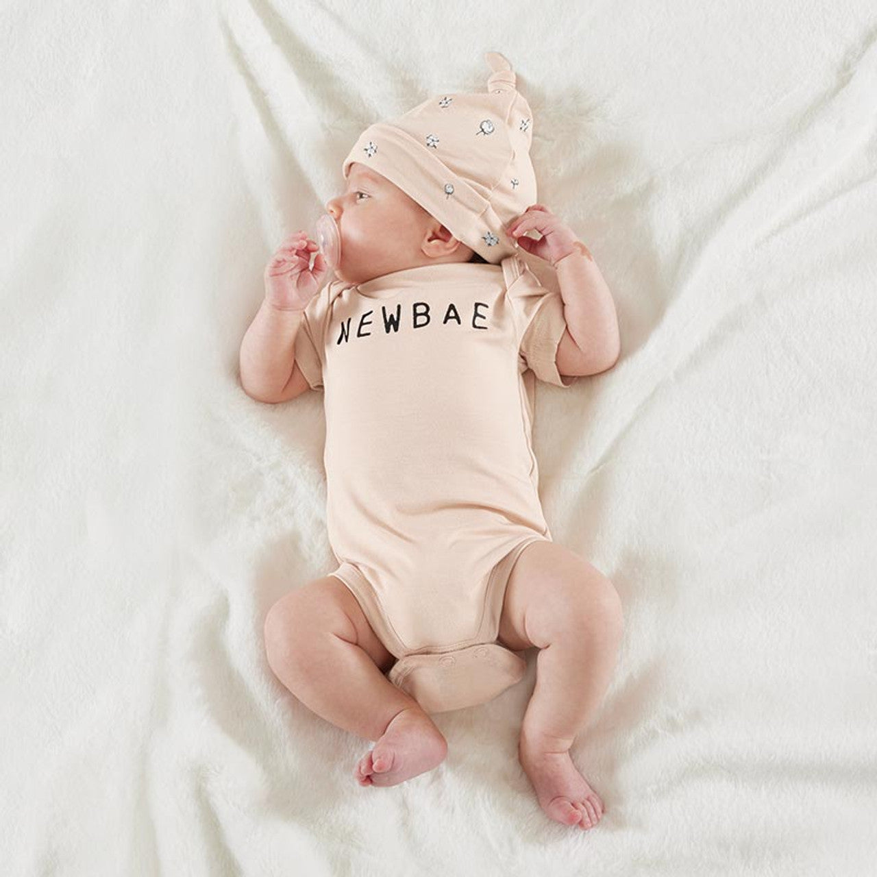NEWBAE" snapshirt and matching cotton blossom printed knotted hat. Sizes: Newborn, 0-3 months.