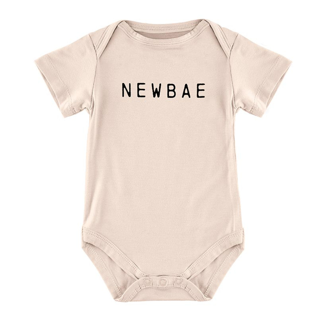 Beige baby onesie with short sleeves and round neck, featuring "NEWBAE" in bold black letters across the chest. Snaps at the bottom for easy diaper changes. Sizes available: Newborn, 0-3 months, 3-6 months.
