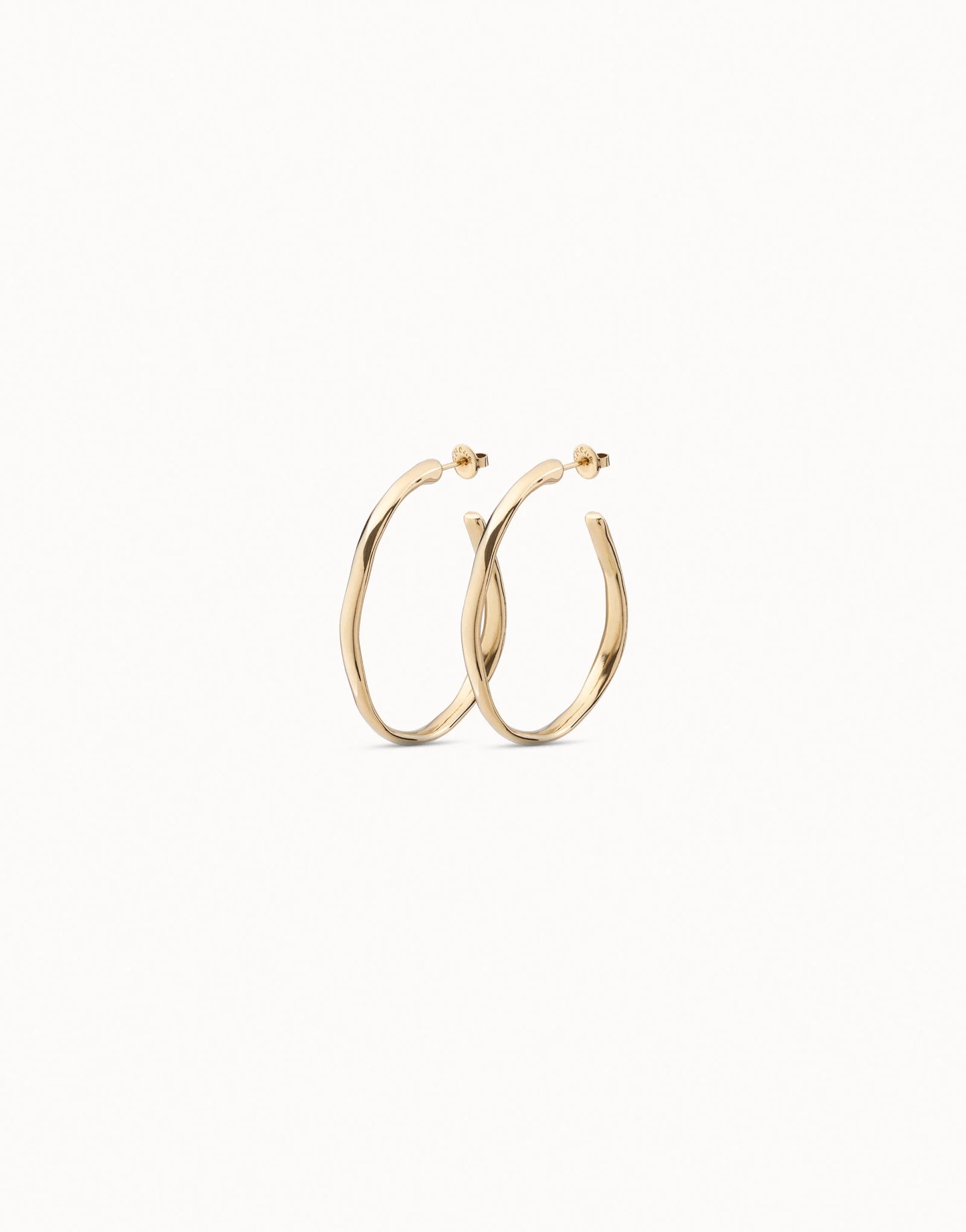 Open Hoop Earrings with shiny 18K gold-plated, subtly twisted handcrafted design inspired by UNOde50; available in multiple sizes.