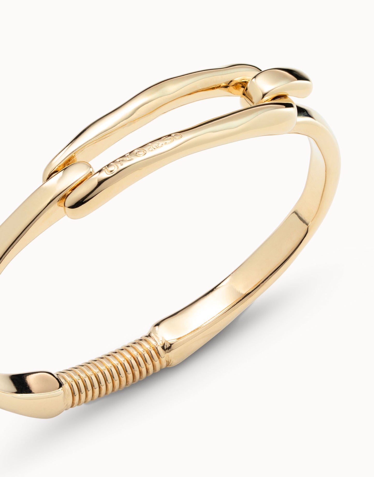 Gold-plated Bangle Bracelet with Buckle, handcrafted in Spain, hinged clasp and ridged coiled detail at the end. Available in S, M, L.