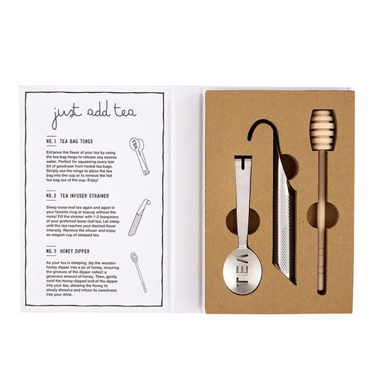 The "Tea Essential Book Box - Spill The Tea" gift set includes a tea bag tong, versatile tea infuser strainer, and honey dipper.