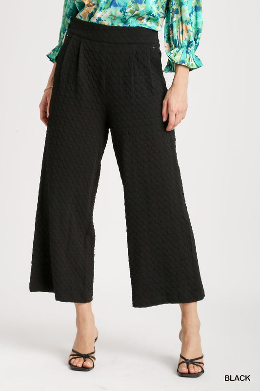 **Square Jacquard Wide Fit Pants**

- Color: Black
- Design: Pleated with an elastic waistband
- Sizes Available: S, M, L, XL