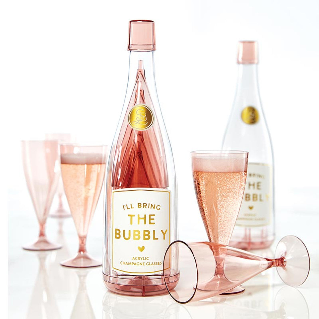 Pink acrylic champagne bottle labeled "I'll bring the bubbly" with stackable glasses. Available in small, medium, and large.