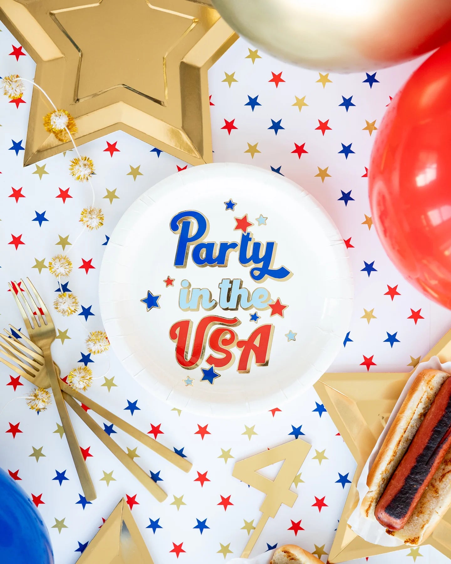 **Party in the USA Plates**
- Sizes: Not specified
- Description: Festive flat lay featuring "Party in the USA Plates" ideal for Fourth of July celebrations.
