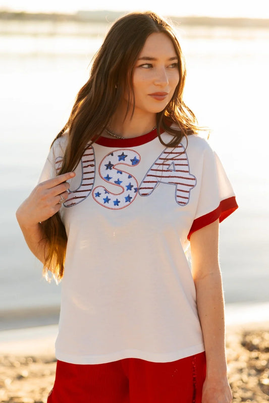 Sequin "USA" White Top with red trim on sleeves and collar, patriotic sequined design. Sizes: XS-XL.