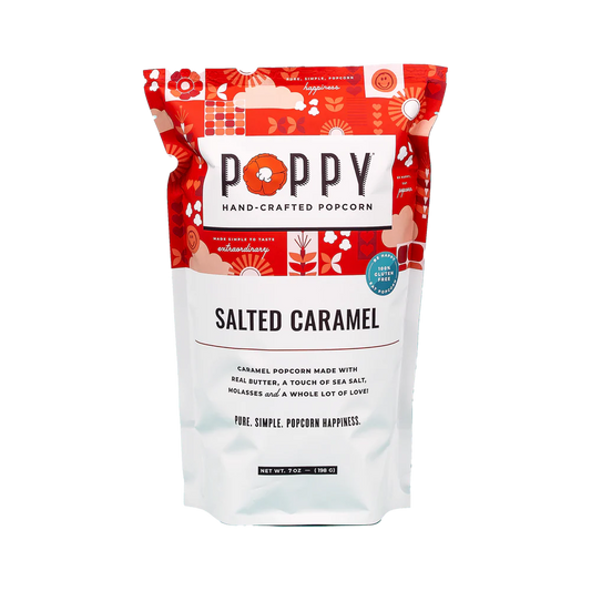This hand-crafted Salted Caramel Poppy Popcorn is gluten-free and comes in a vibrant red and white packet. The packaging details the ingredients and features whimsical patterns.